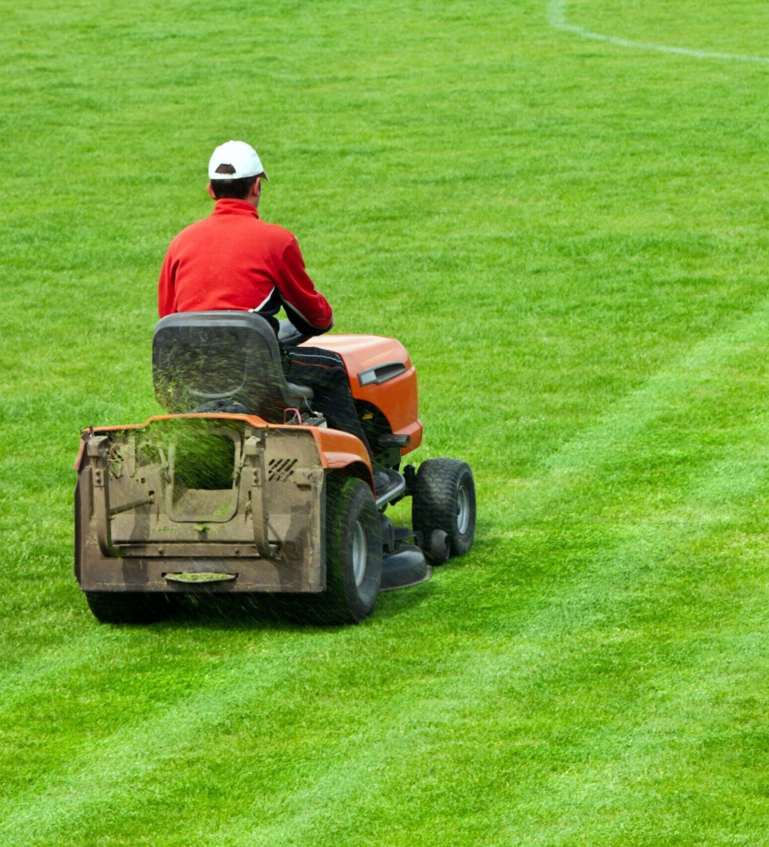 Mowing grass in stadium Greenlii Mowing Services